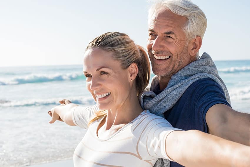 Mature couple enjoying the seaside together